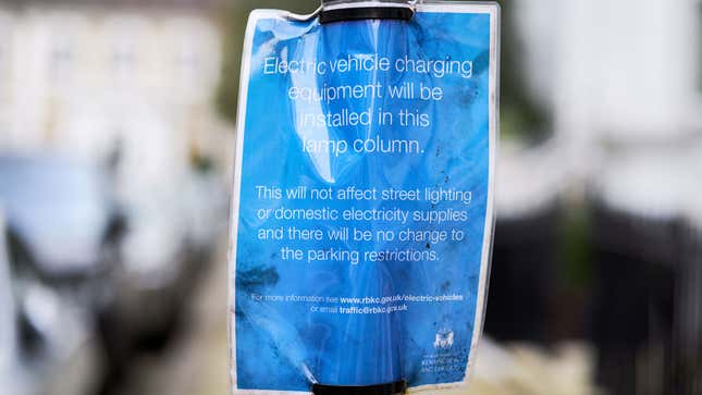 A photo of a sign saying that EV chargers are being installed on a street.