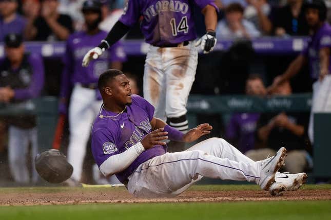 Apr 10, 2023; Denver, Colorado, USA; Colorado Rockies third baseman Elehuris Montero (44) slides into home after being driven in on an RBI in the fourth inning against the St. Louis Cardinals at Coors Field.