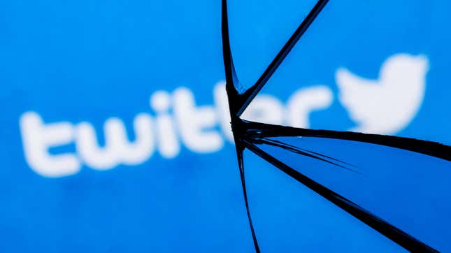 An image of a cracked mirror reflecting the word "Twitter" and the blue bird logo.