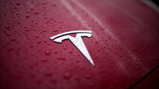 Raindrops gather on the logo of a Tesla Model Y, Thursday, Dec. 15, 2022, in Charlotte, N.C.