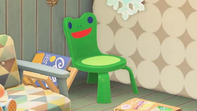A green chair with a happy frog face on its backrest.