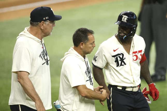 Jul 22, 2023; Arlington, Texas, USA; Texas Rangers right fielder Adolis Garcia (53) is attended to by head trainer Matt Lucero and manager Bruce Bochy (left) after being hit by a pitch in the fourth inning against the Los Angeles Dodgers at Globe Life Field.