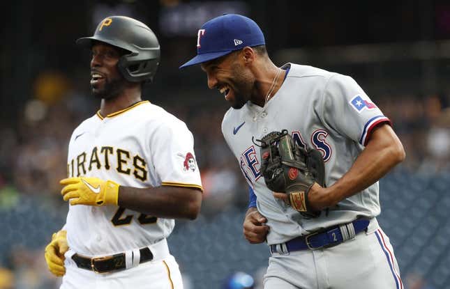 May 22, 2023; Pittsburgh, Pennsylvania, USA; Texas Rangers second baseman Marcus Semien (right) and Pittsburgh Pirates designated hitter Andrew McCutchen (22) react after McCutchen was tagged out in a rundown between third base and home plate on a double steal attempt during the first inning at PNC Park.
