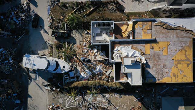 A yacht sits run aground in the front yard of a destroyed home in Fort Myers, Florida on Sunday, October 2.