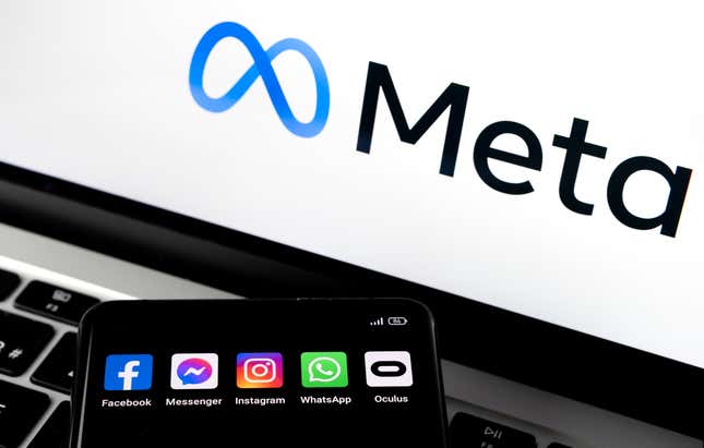 A laptop with the Meta logo and a phone with Meta apps like Facebook and Instagram on it.