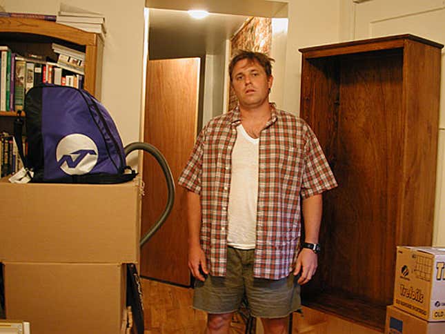 Derek Olson stands among some of the boxes he'd hoped to unpack last week.