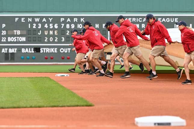 Jun 2, 2023; Boston, Massachusetts, USA; Grounds crew pull a tarp on the field before a game between the Tampa Bay Rays and the Boston Red Sox at Fenway Park.