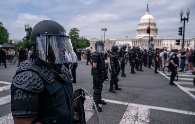 Capitol Police dressed in riot gear watch as activists react to the Supreme Court’s ruling in the Dobbs v Jackson Women’s Health Organization case in front of the U.S. Supreme Court on June 24 in Washington, DC.