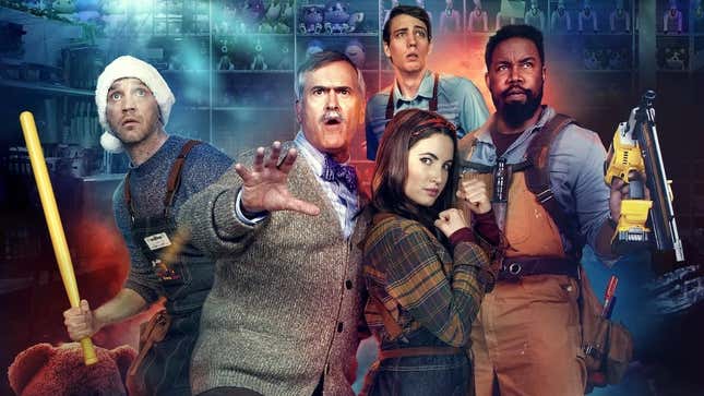 Bruce Campbell, flanked by fellow toy-store employees, holds up a hand as offscreen aliens attack in a promo photo for horror comedy Black Friday.