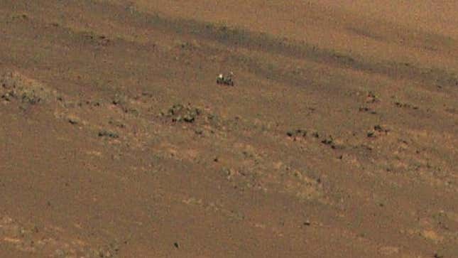 Una imagen granulada del Perseverance entre algunas rocas en Marte, capturada por el Ingenuity el 4 de agosto.
