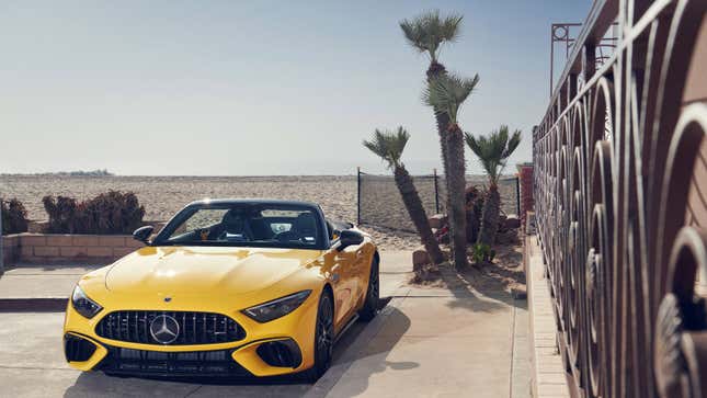 A photo of a yellow Mercedes-Benz SL roadster. 