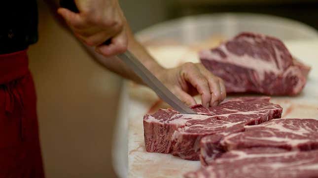 Person cutting raw meat