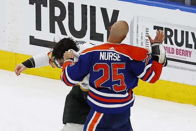 May 10, 2023; Edmonton, Alberta, CAN;  Edmonton Oilers defensemen Darnell Nurse (25) and Vegas Golden Knights defensemen Nicolas Hague (14) fight during the third period in game four of the second round of the 2023 Stanley Cup Playoffs at Rogers Place.