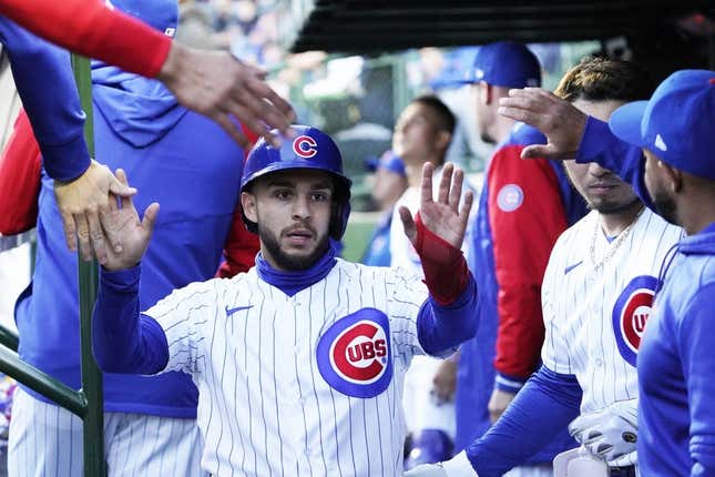 May 9, 2023; Chicago, Illinois, USA; Chicago Cubs infielder Nick Madrigal (1) is greeted in the dugout after scoring against the St. Louis Cardinals during the first inning at Wrigley Field.