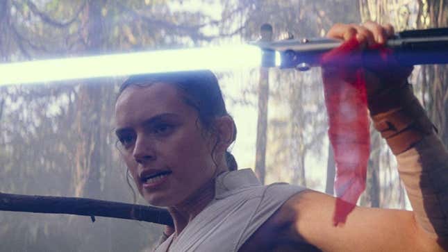 Rey with a lightsaber.