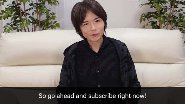 Masahiro Sakurai sits on a cream-colored couch, delivering sage game design wisdom from his new YouTube channel, Masahiro Sakurai on Creating Games.