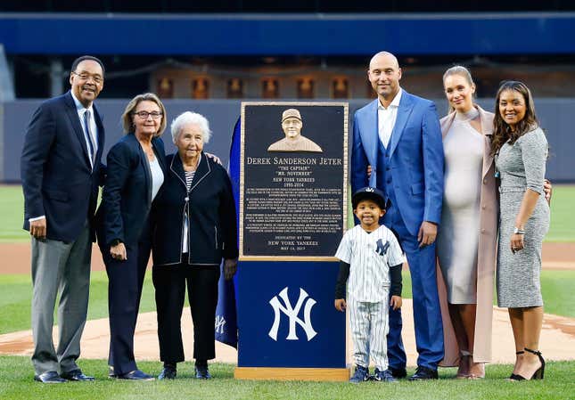 Derek Jeter poses with his Monument Park plaque with, from left, father Charles, mother Dorothy, grandmother Dot, nephew Jalen, wife Hannah and sister Sharlee during his number retirement ceremony at Yankee Stadium on May 14, 2017 in the Bronx borough of New York City