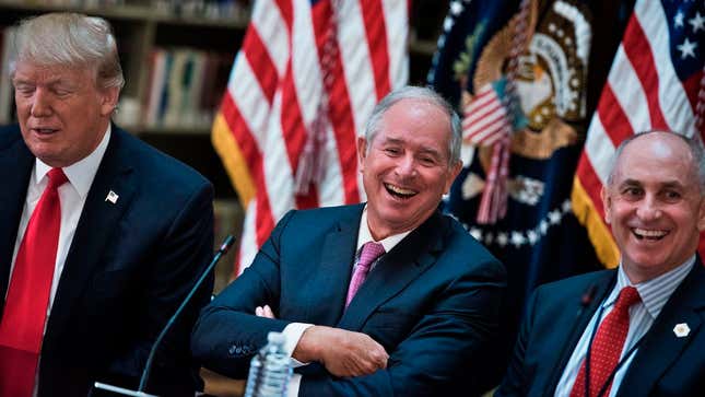 Stephen A. Schwarzman (center), CEO of the Blackstone Group which is purchasing a majority stake in Ancestry.com, sits with President Donald Trump (left) and Chris Liddell (right) at the White House on April 11, 2017.