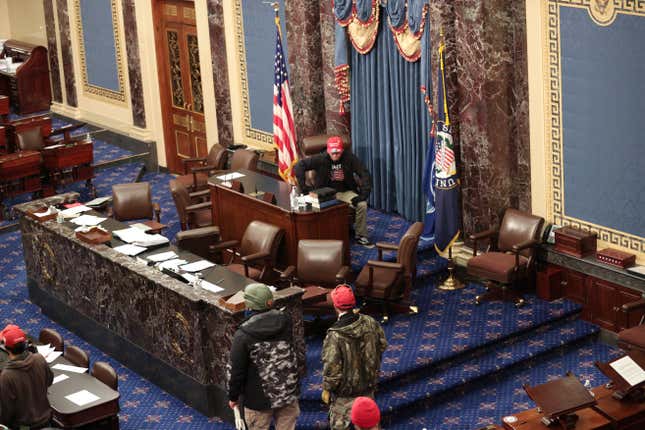  Protesters enter the Senate Chamber on January 06, 2021 in Washington, DC.
