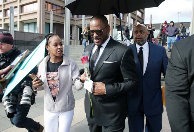 A fan hands singer R. Kelly a rose after his court date at the Leighton Courthouse on March 22, 2019 in Chicago, Illinois. R. Kelly appeared before a judge to request permission to travel to Dubai to work several concerts.