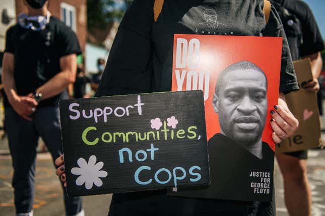 A person holds a sign of George Floyd during a demonstration on August 17, 2020 in Minneapolis, Minnesota. Community members came together for a rally to protest the city’s potential forceful reopening 38th Street and Chicago Ave, an unofficial autonomous zone known as George Floyd Square. 
