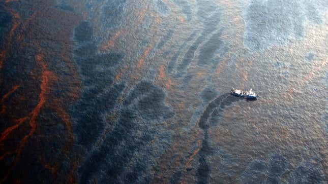 A boat cleans up oil during the 2010 Deepwater Horizon oil spill.