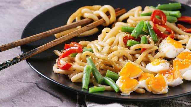 Plate of sesame udon noodles with chopsticks