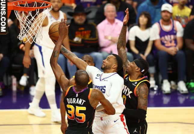 Apr 18, 2023; Phoenix, Arizona, USA; Los Angeles Clippers guard Norman Powell (center) drives to the basket against Phoenix Suns forward Kevin Durant (35) and Torrey Craig in the second half during game two of the 2023 NBA playoffs at Footprint Center.