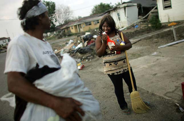 EW ORLEANS - MAY 09: (NETHERLANDS OUT) Shanika Reaux talks with Stephen Ford as she cleans in front of her residence in the Lower Ninth Ward May 9, 2006 in New Orleans, Louisiana. Reaux’s home in the Lower Ninth Ward was destroyed by Hurricane Katrina before she ever got the chance to move in last August. Reaux says she and her family moved into a donated gutted home in the Lower Ninth in February after FEMA would no longer pay for her housing once she returned to the state of Louisiana. The water is unsafe to drink in the area and many homes are completely destroyed.