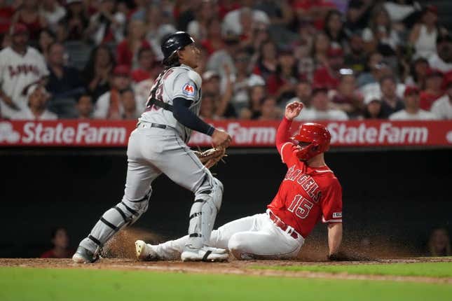 Sep 8, 2023; Anaheim, California, USA; Los Angeles Angels left fielder Randal Grichuk (15) slides into home plate to beat a throw to Cleveland Guardians catcher Bo Naylor (23) to score in the fourth inning at Angel Stadium.