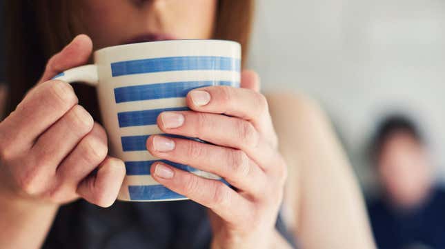 Woman sipping from warm mug
