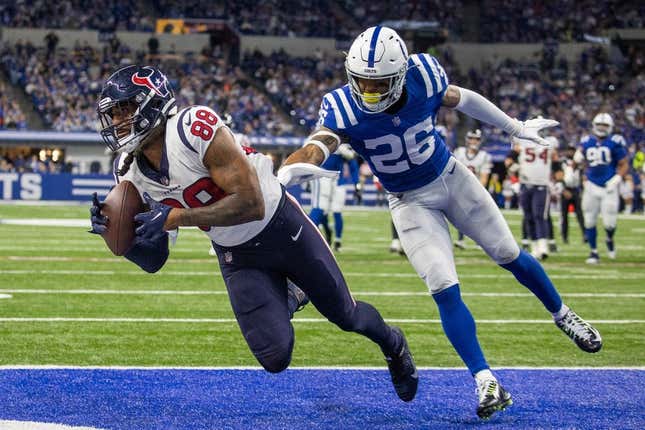 Jan 8, 2023; Indianapolis, Indiana, USA; Houston Texans tight end Jordan Akins (88) catches a touchdown pass while Indianapolis Colts safety Rodney McLeod Jr. (26) defends in the third quarter at Lucas Oil Stadium.