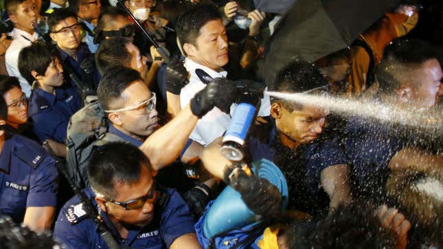 Hong Kong police spray protesters with pepper spray during clashes on Oct. 16.