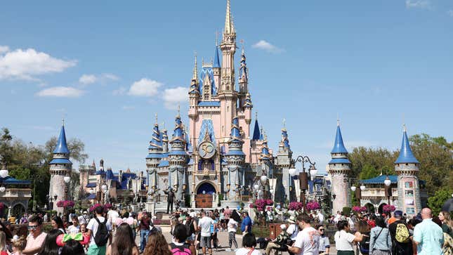 A view of the Cinderella Castle on a sunny day at Disney World with crowds milling about