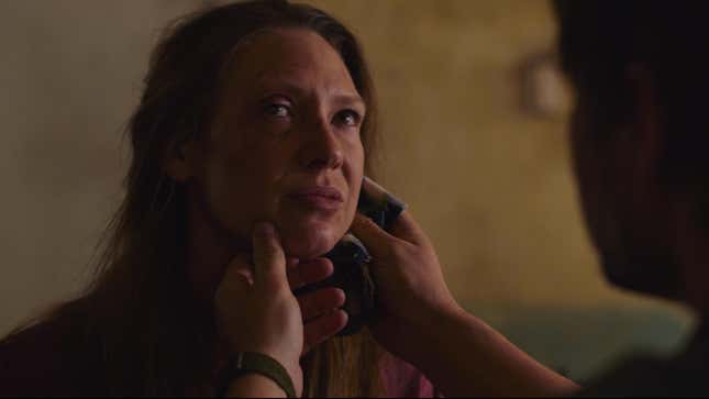 Joel tends to wounds on Tess' face in a scene from HBO's The Last of Us.