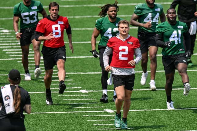 May 23, 2023; Florham Park, NJ, USA; New York Jets quarterback Aaron Rodgers (8) and quarterback Zach Wilson (2) warm up during OTA s at Atlantic Health Jets Training Center.