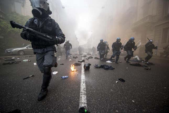 Riot police in Milan advancing during clashes following a protest against the Milan’s Expo 2015