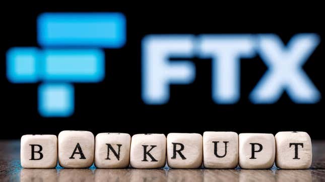 The FTX logo in the background, blurred, and in the foreground a few cubes read "bankrupt"