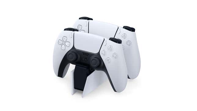 Two Sony PS5 DualSense controllers charge on a charging dock.