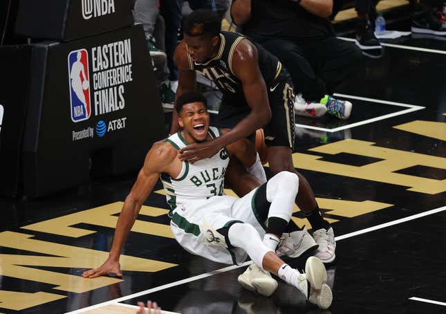 JUNE 29: Giannis Antetokounmpo, No. 34, of the Milwaukee Bucks is injured against Clint Capela, No. 15, of the Atlanta Hawks during the second half in Game Four of the Eastern Conference Finals at State Farm Arena on June 29, 2021 in Atlanta, Georgia.