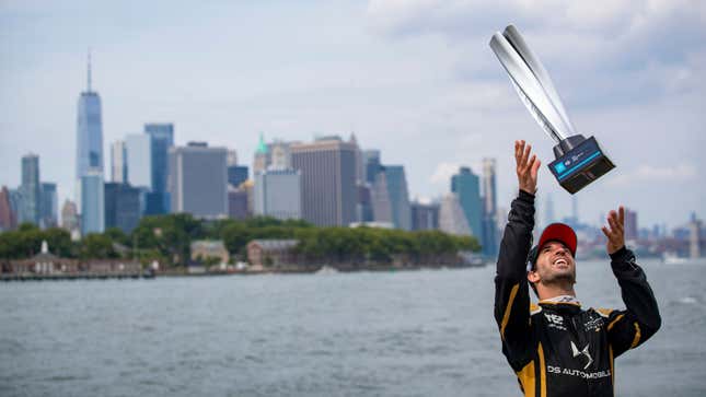 A photo of Antonio Felix da Costa throwing his New York trophy into the air.