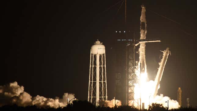 A photo of a Space X Falcon 9 rocket lifting off at night. 
