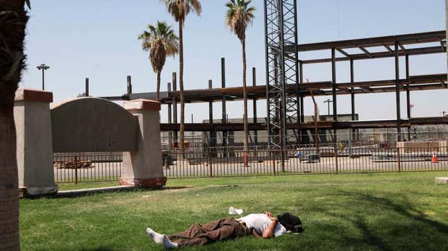  A man lay on the grass as the temperature reached 115 degrees in California this June. 