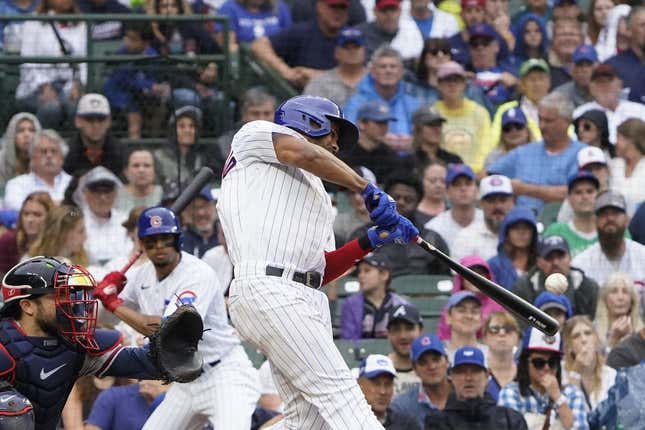 Aug 6, 2023; Chicago, Illinois, USA; Chicago Cubs first baseman Jeimer Candelario (9) hits a one run single against the Atlanta Braves during the fifth inning at Wrigley Field.