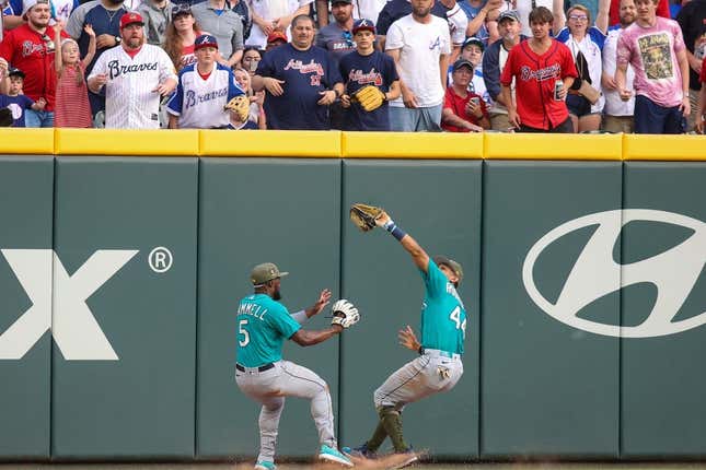 May 20, 2023; Atlanta, Georgia, USA; Seattle Mariners center fielder Julio Rodriguez (44) collides with left fielder Taylor Trammell (5) after a catch against the Atlanta Braves in the second inning at Truist Park.
