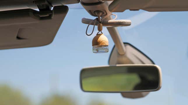An air freshener hanging on a rearview mirror