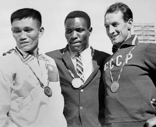Johnson (c.) after a gold-medal performance at the Rome games in 1960.