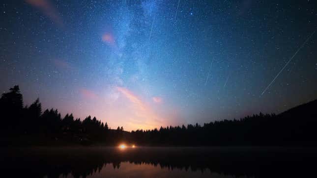 the perseids summer meteor shower above a lake