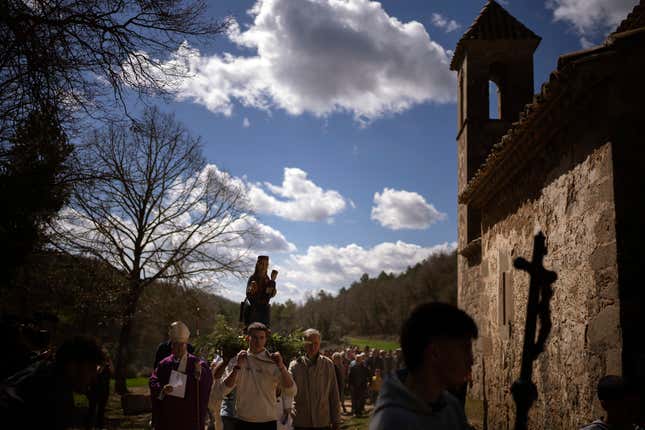 Local residents take part in a procession carrying a statue of the Our Lady of the Torrents, a virgin historically associated with drought, in l’Espunyola, north of Barcelona, Spain, Sunday, March 26, 2023.
