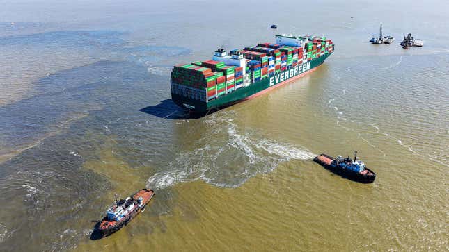 Tug boats pull on the Ever Forward container ship.